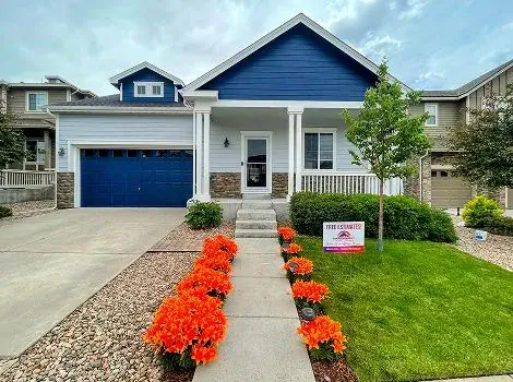 Exterior house painting in navy blue with white trim by Panoramic Pro Painting Denver